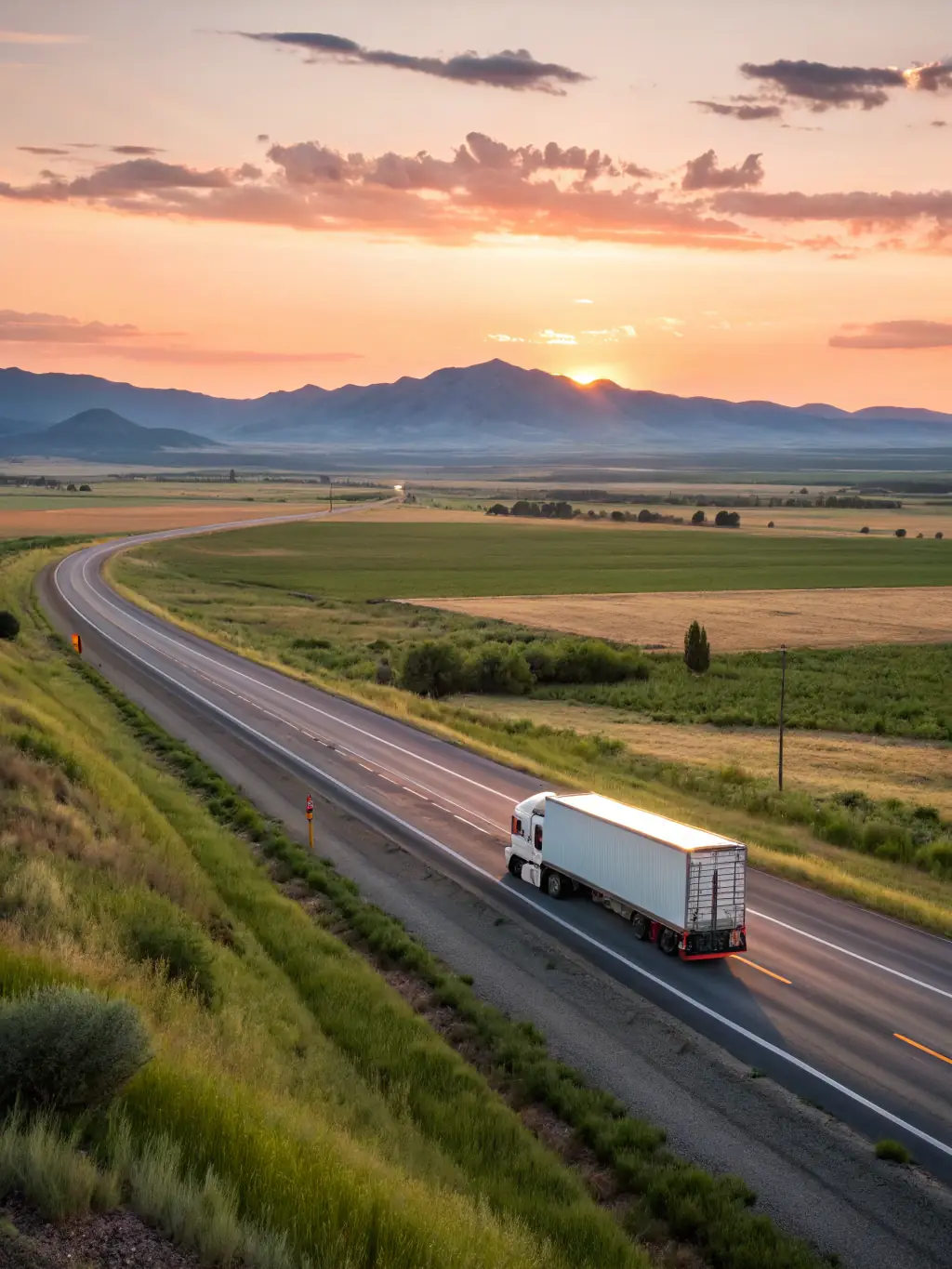 An impressive image of an 18-wheeler truck on a long stretch of road, representing long-haul transport capabilities.